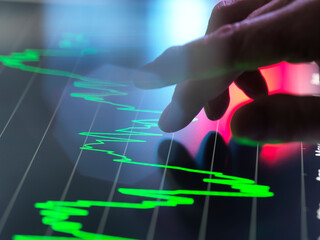 Analysts viewing financial performance data on touch screen