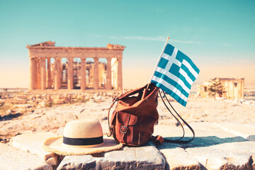 Summer hat, bag and Greek flag at Parthenon ofAthens,  Acropolis- Travel, vacation or tour tourism...