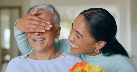 Adult daughter, mothers day or surprise of flowers, congratulations or excited. Senior mom, woman or floral gift, thank you present or celebration, gratitude or cover eyes for love on holiday in home