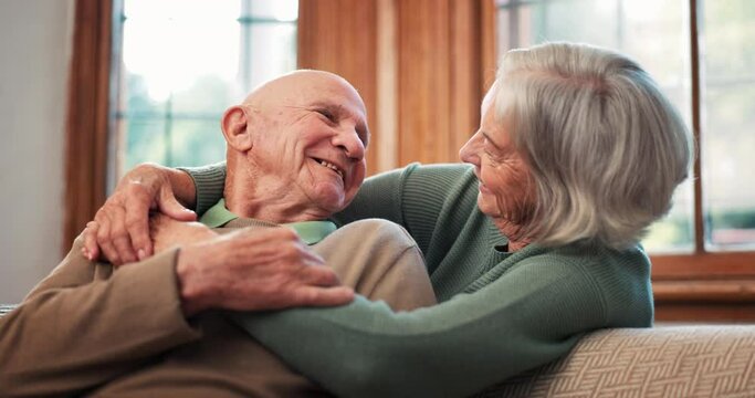 Senior couple, kiss and hug in home for love, care and together for romance, retirement or marriage. Elderly woman embrace man for loyalty, commitment or relax for trust, affection or support partner