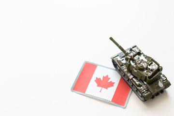 Toy tank with Canada flag on green background