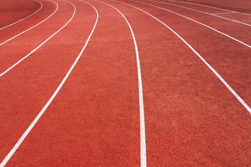 close up red running track, sports court or playground background with white line.