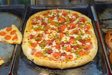 Slices of pizza at a street stall.