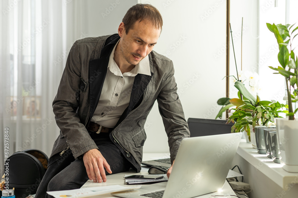 Aufkleber trading stocks online. back view of young businessman or trader working with graph and charts on com