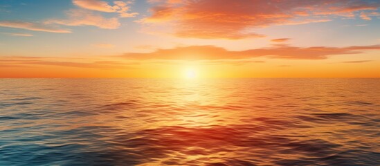 Naklejka na ściany i meble The evening sunset and the beautiful sunlight reflecting upon the sea