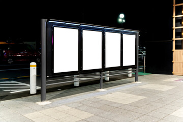 Row of blank vertical billboard on Sidewalk at Night