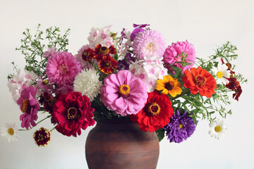 a bouquet of flowers in close-up as a background. zinnias, phlox and asters.