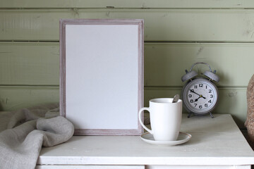 a mockup cottage with an empty frame on the table.