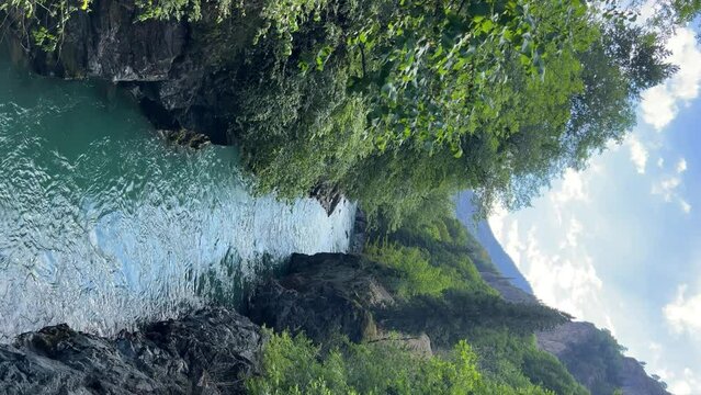 The Bolshaya Laba River. A mountain emerald river in a narrow, sunlit canyon. Bolshaya Laba River near the village of Psemen in Karachay-Cherkessia, Russia. Panoramic view. 4K