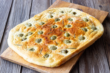 Focaccia with olives and rosemary. Italian food. Vegetarian food.
