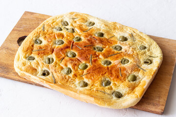 Focaccia with olives and rosemary. Italian food. Vegetarian food.
