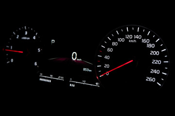 Fototapeta premium Close up shot of speedometer in car. Car dashboard. Dashboard details with indication lamps.Car instrument panel. Dashboard with speedometer.