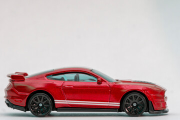 Fototapeta na wymiar Toy red sportcar on a white background