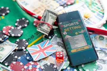 Smartphone with poket table on screen, playing cards and chip cards on poker table. Online casino.