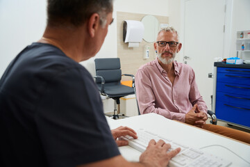 Bearded male with glasses at a doctors appointment