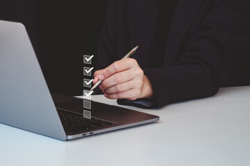 Business performance checklist, businessman using laptop doing online checklist survey, filling out...