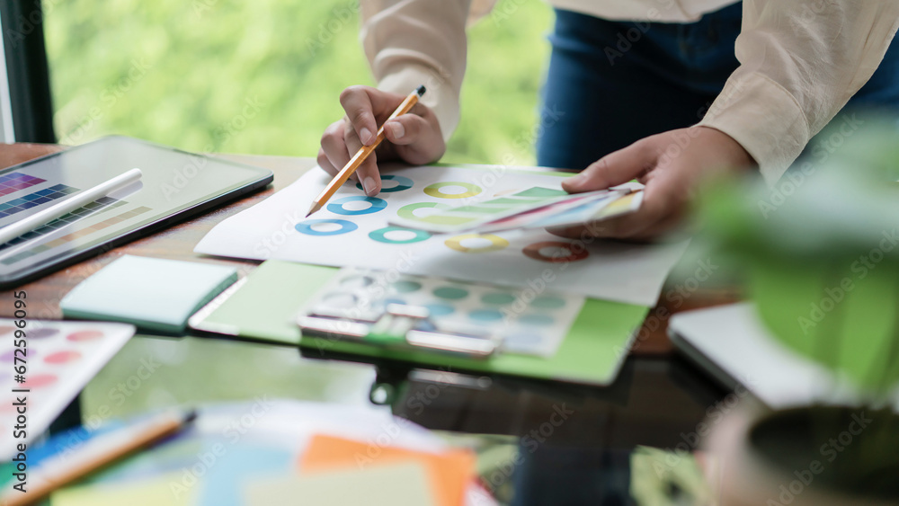 Poster creative graphic designer holding color swatch to comparing color on document for designing project