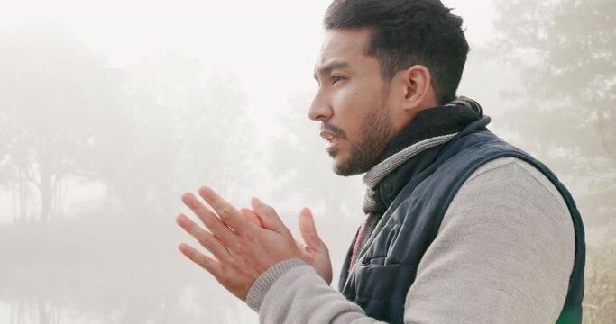 Winter, man and rub hands in nature with fog on holiday, vacation and travel outdoor. Cold, thinking and person in forest, woods or countryside with freezing weather on adventure, hiking or trekking