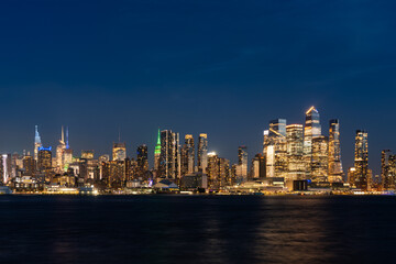 Fototapeta na wymiar New York west side skyline at night with lights, panoramic business skyscrapers