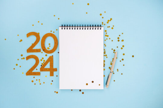 New Year empty goals, plans, resolutions 2024 concept with empty notebook and pen. flat lay style. Christmas planning concept with space for text