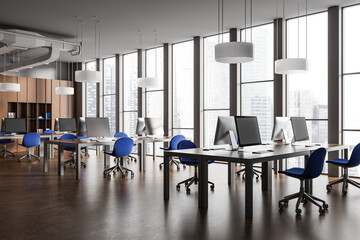 Stylish office room interior with pc computers on table, shelf and window