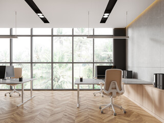 Modern office interior with table and armchiar, pc monitors and sideboard