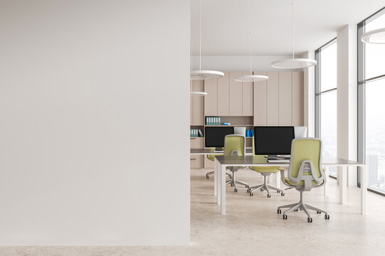 Beige and white open space office with blank wall