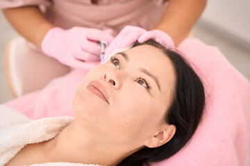 Obraz na płótnie Canvas Esthetician specialist gives beauty injections to a woman