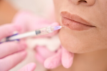Injection lip rejuvenation procedure in a cosmetology salon