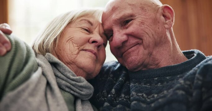 Face, love and senior couple hug in a living room with support, care and trust in their home together. Security, care and old people embrace in a house bonding, relax and enjoy retirement together