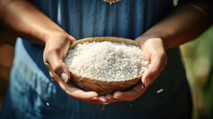 Close-up of a female farmer holding Thai white rice seeds.