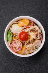 Delicious fresh salad with chicken, quail eggs, cherry tomatoes, lettuce
