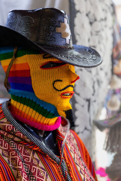 The mannequin is dressed in a knitted cap and a leather hat. Knitted Peruvian traditional products