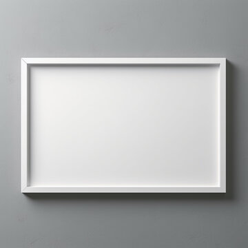 empty white picture frame lying on grey wall