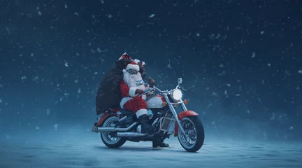 Poster Biker Santa Claus posing on a motorcycle © stokkete