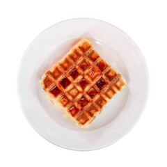 Belgian waffle with cherry jam on plate, top view, isolated on white background with clipping path