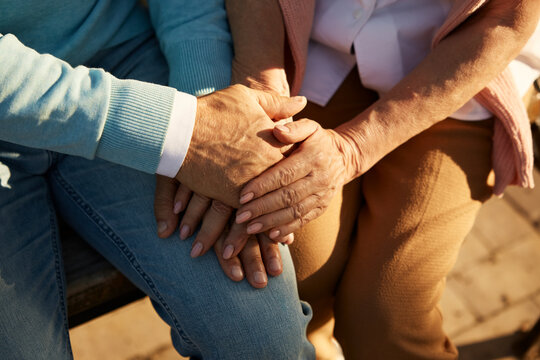 Closeup view of senior couple hands in hands together