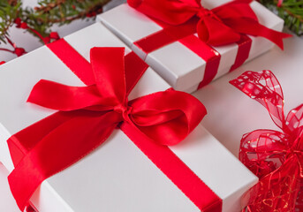 White and red Christmas presents with large festive bows.