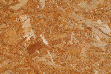 Chipboard yellow plywood, surface close-up, uniform texture background, glued wood chips