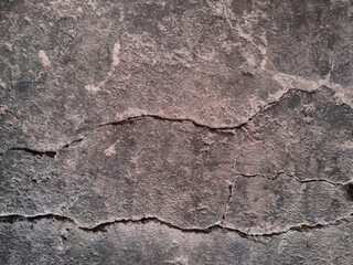 Grungy wall of gray concrete texture with cracked surface from sand and cement materials.