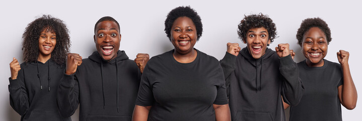 Collage image of happy mixed race young people clench fists celebrates success dressed in casual black clothing stand next to each other isolated over white background. People enjoy triumph.