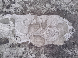 Grungy wall of gray concrete texture with cracked surface from sand and cement materials.