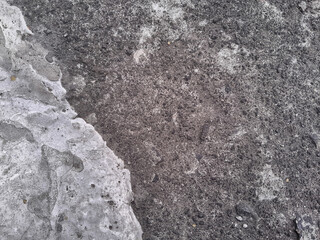 Grungy wall of gray concrete texture with cracked surface from sand and cement materials.
