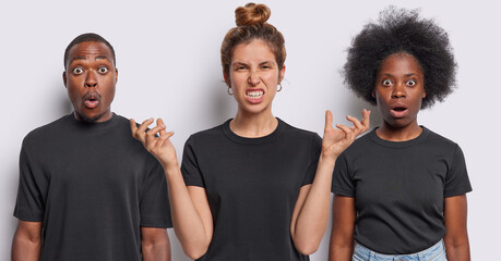 Collage of three mixed race young people stares bugged eyes and gesture with annoyance express disbelief and irritation dressed in casual black t shirts stand in row against white background