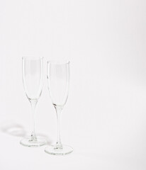 Two empty wine or champagne glasses isolated on white background. Copy space for text. Enjoying romantic weekend.