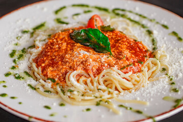 Italian classic pasta spaghetti with basil, close-up, selective focus