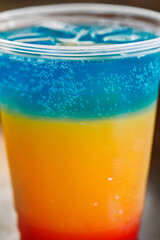 Cocktail three - tiered in plastic cup, close-up, selective focus