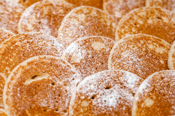 Pancakes sprinkled with powdered sugar, close-up, selective focus