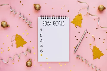 Foto op Canvas New year resolutions 2024 on desk. 2024 goals list with notebook on festive pink background. Resolutions, plan, goals, actions, checklist, idea concept © olyphotostories