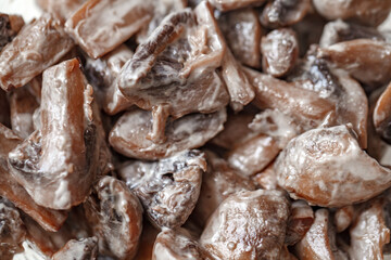 Mushrooms champignons stewed in sour cream sauce, close-up, selective focus